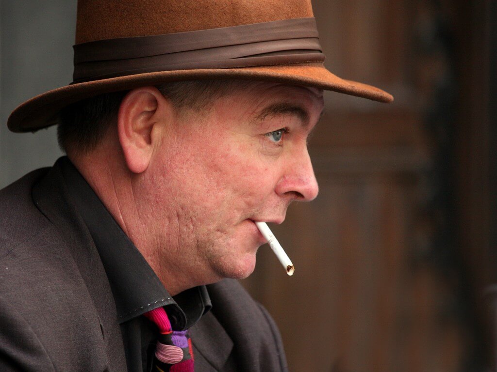 profile of man with unlit cigareet